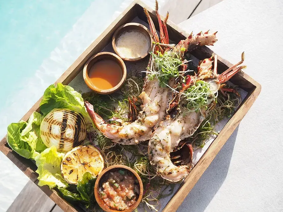 Grilled lobster platter served poolside at Azure Beach Club