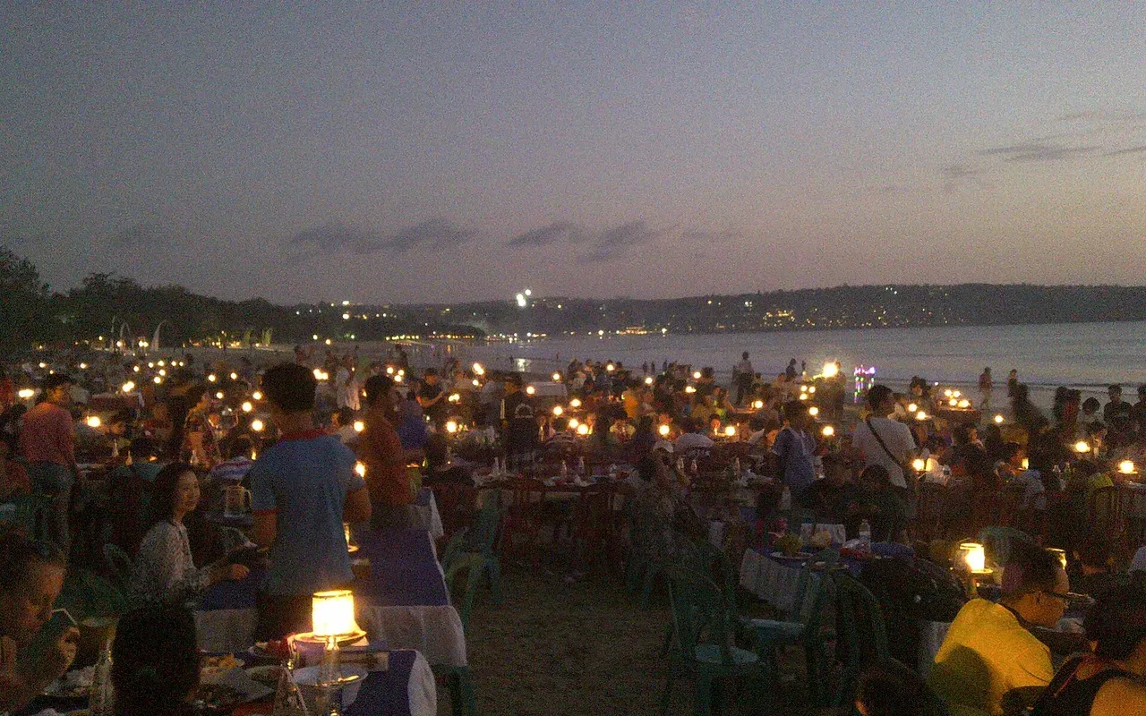 Jimbaran seafood dinner served on the sand at dusk