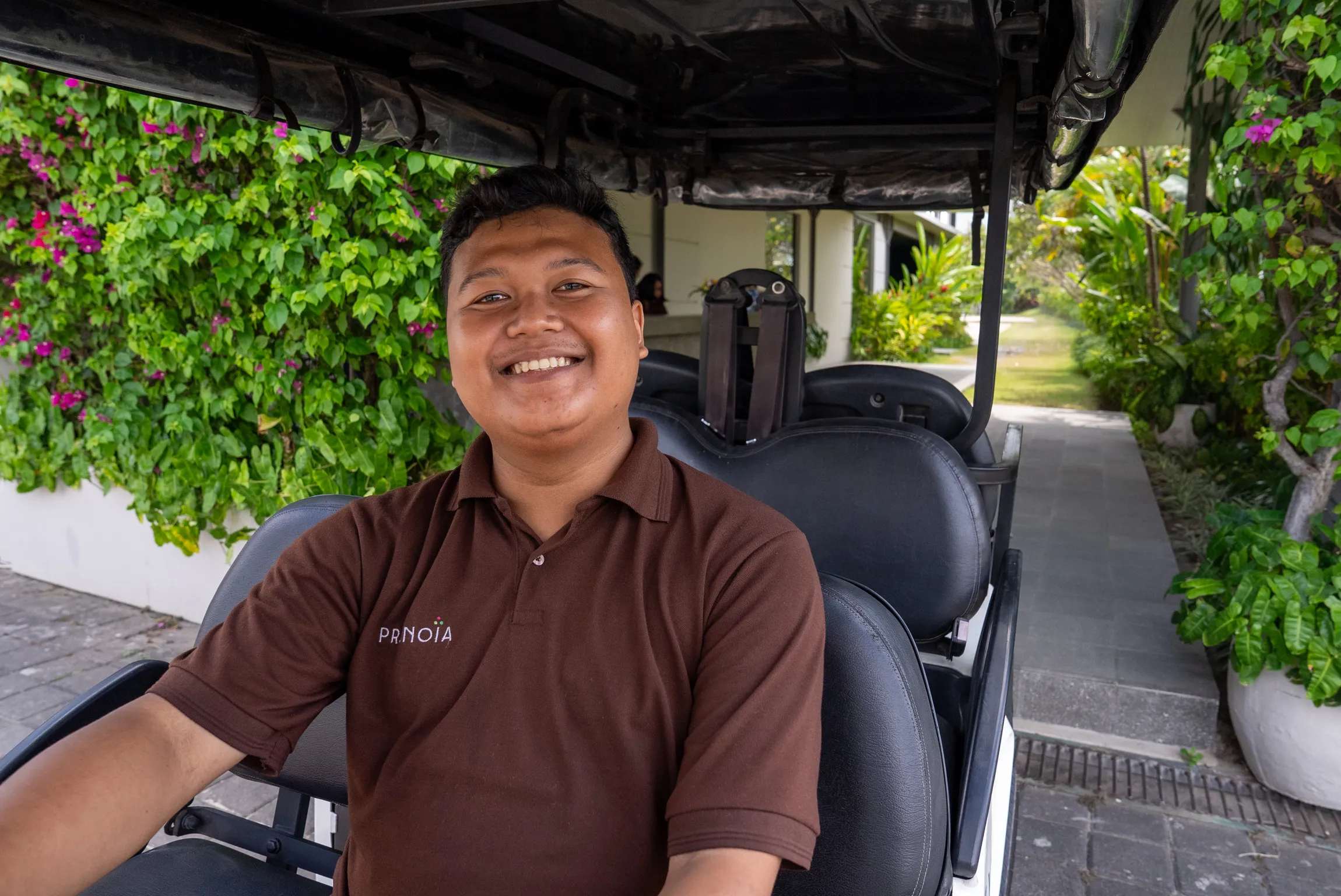 Pronoia concierge driver beside the estate buggy
