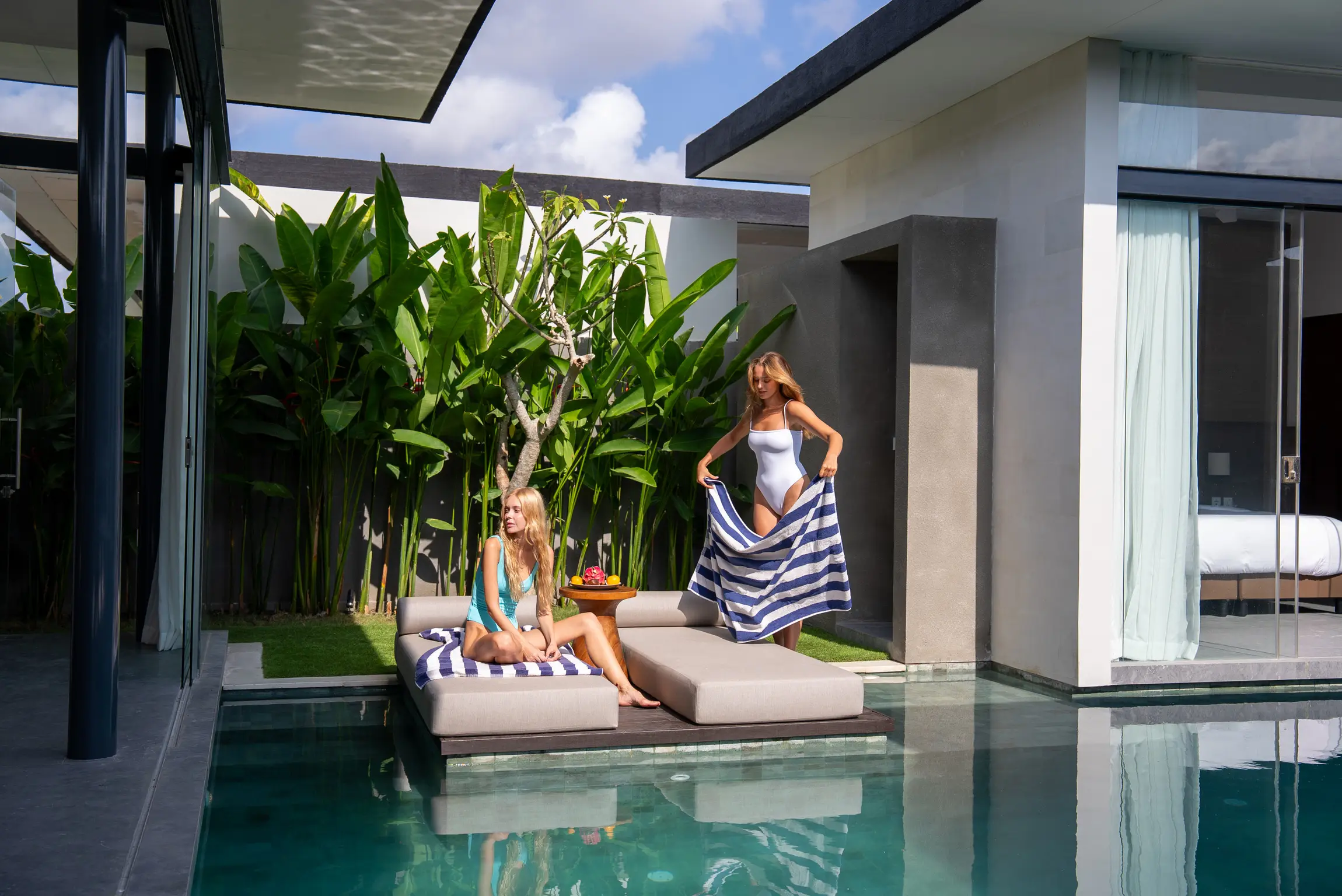 Two women beside a private-pool villa at Pronoia